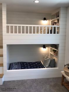 a bunk bed built into the side of a wall in a room with carpeted flooring