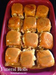 a pink tray filled with lots of sliders covered in gravy and cheese