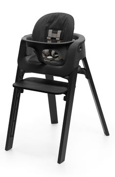 a black high chair that is on top of a white background with the seat up