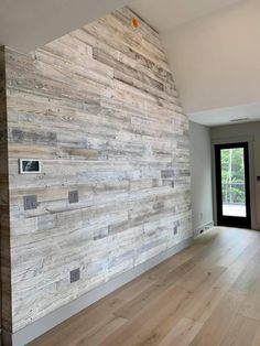 an empty room with wood paneling on the wall