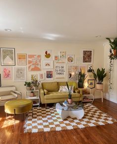 a living room filled with furniture and pictures on the wall