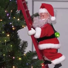 a santa clause climbing up a ladder next to a christmas tree