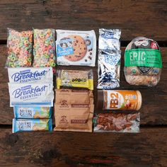 an assortment of snacks laid out on a wooden table