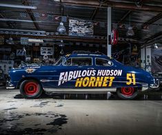 an old blue car with the name fabulous hudson hornet painted on it's side