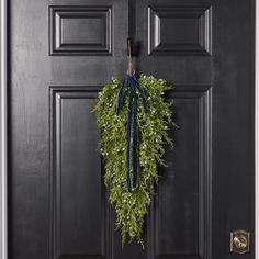 a wreath is hanging on the front door