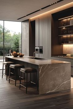 a modern kitchen with marble counter tops and stools next to an open floor plan