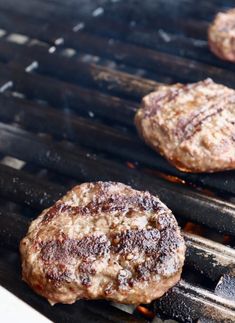 hamburger patties cooking on an outdoor grill