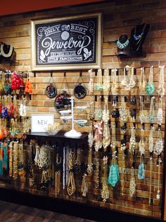 an image of a store display with jewelry on the wall and in front of it