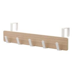 a wooden shelf with three hooks on it