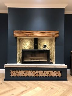 a fire place with logs on the bottom