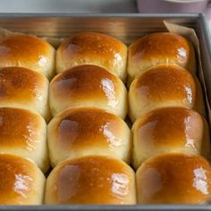 a pan filled with rolls sitting on top of a table