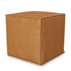 a brown leather cube ottoman sitting on top of a white floor