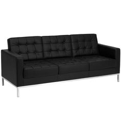 a black leather couch sitting on top of a white floor next to a metal frame