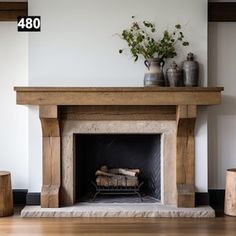 a living room with a fire place in the center and vases on top of it