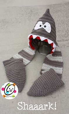 a crocheted shark scarf is shown with its mouth open