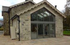 a stone building with glass doors and windows