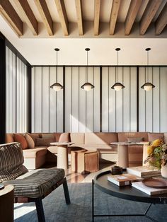 a living room filled with furniture and lots of wood planks on the walls above