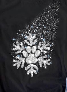 someone wearing a black shirt with white snowflakes on it