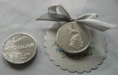 a close up of a coin on a table with a ribbon and tag attached to it