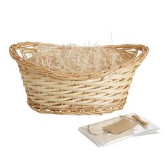 a wicker basket filled with hay next to a package