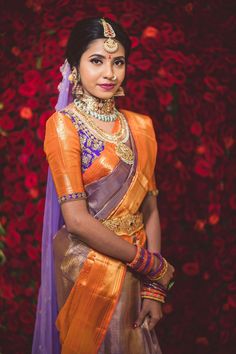 a woman in an orange and purple sari