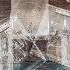 three clear bags with writing on them sitting on a wooden table next to each other