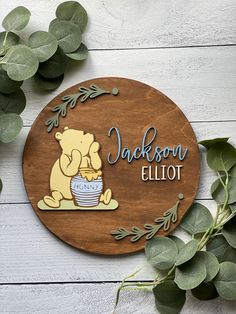 a wooden sign with a bear holding a bowl of food on it's side