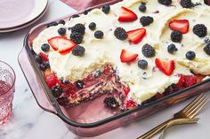 a cake with berries and cream frosting in a pan