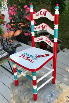 the cat in the hat chair is painted red, white and blue with words on it