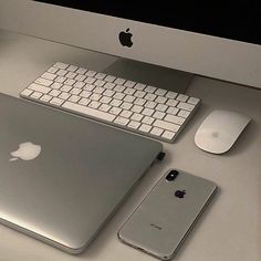 an apple computer, keyboard and mouse are sitting on a desk next to each other