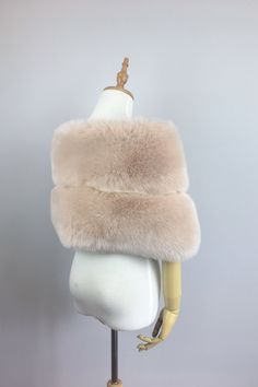 a mannequin with a fur stole on it's head