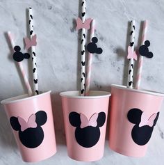 three cups with straws in them decorated like minnie mouse heads and bows on them