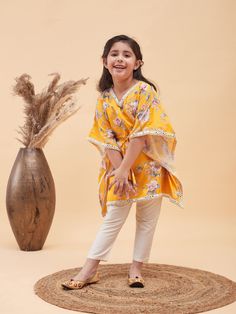 Vastramay Girls Yellow Floral Printed Kaftan Kurta With Cream Pant Set A delightful ensemble for young girls, this set features a vibrant yellow floral printed kaftan kurta paired with cream pants. Perfect for festive occasions or casual outings, this outfit is both comfortable and stylish. Features: Yellow floral printed kaftan kurta Cream pants for a coordinated look Comfortable and breathable fabric Perfect for festive occasions or casual wear Specifications: Brand: VASTRAMAY Color: Yellow an Traditional Beach Sets For Spring, Traditional Spring Beach Sets, Traditional Yellow Summer Sets, Yellow Floral Print Spring Sets, Spring Yellow Floral Print Sets, Festive Yellow Printed Sets, Yellow Festive Sets For Spring, Cream Pant, Kaftan Kurta