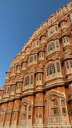 a large building with many windows and balconies on the top of it's sides