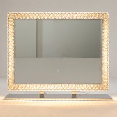 an illuminated mirror sitting on top of a table