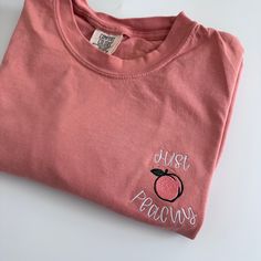 My absolute favorite tee! This 'just peachy ' tee is embroidered on a Comfort Colors short sleeve unisex tee.  Please wash on gentle cycle and dry on low.  If you are wanting a different design, wording, or a different clothing style, please send me a message so we can discuss the details. Please include thread color at checkout If you need this order rushed, please add these to your cart: https://www.etsy.com/listing/1043569716/rush-my-order-for-t-shirts?ref=shop_home_active_19&frs=1 Rush my or Cute Peach T-shirt With Crew Neck, Peach Relaxed Fit Crew Neck T-shirt, Cute Pink T-shirt With Letter Embroidery, Pink Crew Neck T-shirt With Embroidered Graphics, Heather Peach Cotton Short Sleeve T-shirt, Heather Peach Short Sleeve Cotton T-shirt, Heather Peach Cotton T-shirt, Casual Peach Cotton T-shirt, Pink T-shirt With Embroidered Graphics And Relaxed Fit