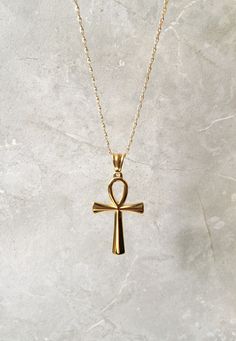 The necklace and pendant are 18kt gold plated over stainless steel. Gold-tone Cross Pendant Jewelry Gift, Gold Ankh Necklace With Adjustable Chain, Gold Ankh Necklace Gift, Gold Ankh Necklace For Gift, Gold Spiritual Cross Necklace In Stainless Steel, Gold Stainless Steel Spiritual Cross Necklace, Gold Ankh Cross Necklace Gift, Yellow Gold Stainless Steel Cross Pendant Necklace, Gold Stainless Steel Cross Necklace As Gift