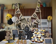 a kitchen decorated for halloween with decorations and buntings hanging from the ceiling in front of an oven