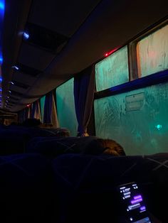 the inside of a bus with people sitting in it