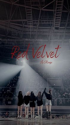 four girls standing in front of a stage with the words red velvet written on it