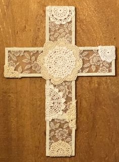 the cross is decorated with lace and flowers