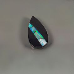 This listing is an Intarsia cabochon. The inlays are on black jade backing. This is a one of a kind creation and is designer quality.  Most all of the rough used is natural and untreated material. The dimensions of this stone are 12mm x 30mm 5mm. The weight of this pieces 20 ct. Nice bright flash and color. Great pear shape for a pendant. Handmade Black Opal Jewelry, Oval Black Opal Jewelry, Black Oval Opal Jewelry, Unique Black Teardrop Jewelry, Gem Silica, Gemstone List, Inlay Jewelry, Black Jade, Mookaite Jasper