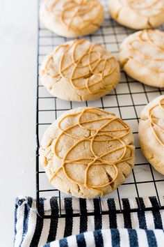 cookies with peanut butter frosting sitting on a cooling rack, ready to be baked