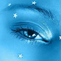 a woman's eye with stars painted on it