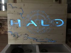 a wooden sign with the word halo painted on it in front of a stove top