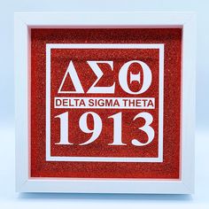 a red and white framed sign with the words delta sigma theater on it