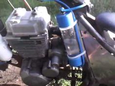 the front end of a blue motorcycle parked in grass