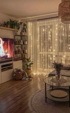 a living room filled with furniture and a flat screen tv sitting on top of a wooden floor