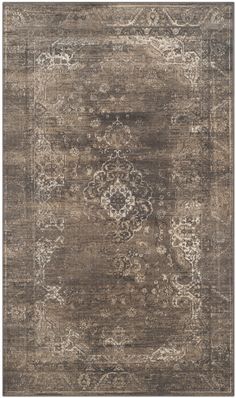 a large area rug with an ornate design on the top and bottom, in dark brown tones