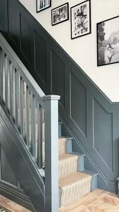 a staircase with pictures on the wall and carpeted stairs leading up to the second floor